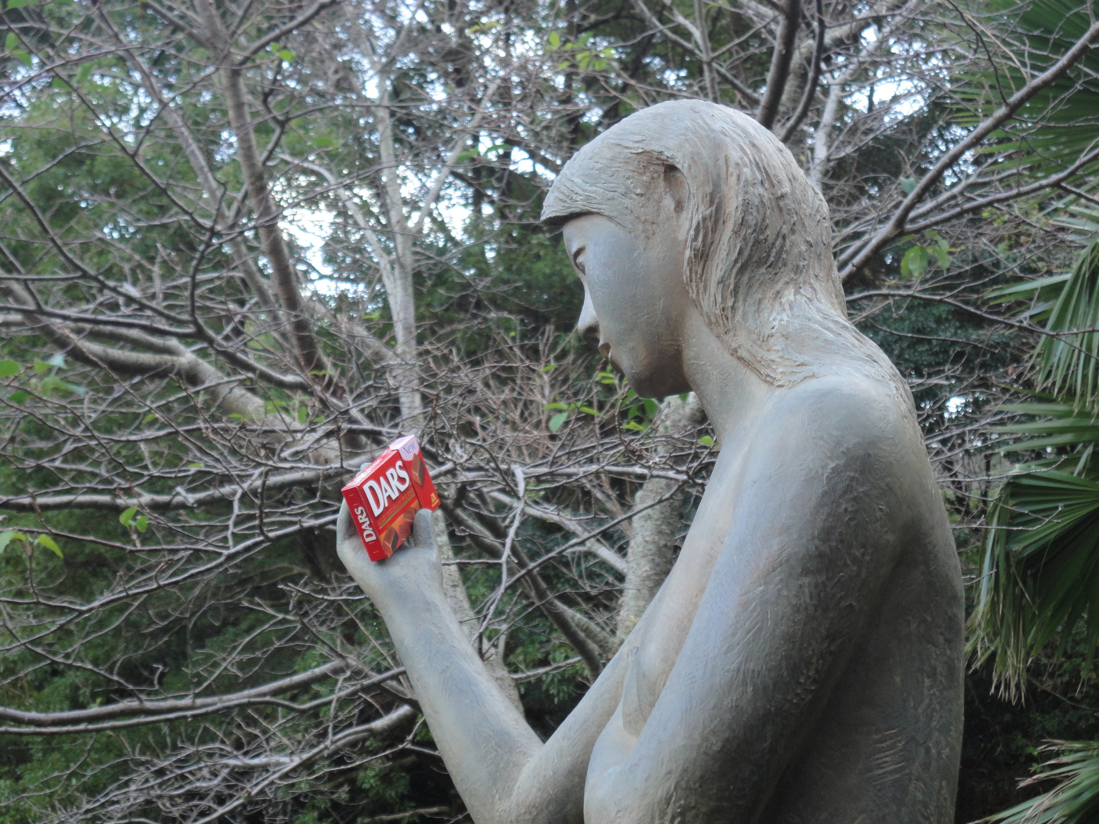 statue holding Japanese candy